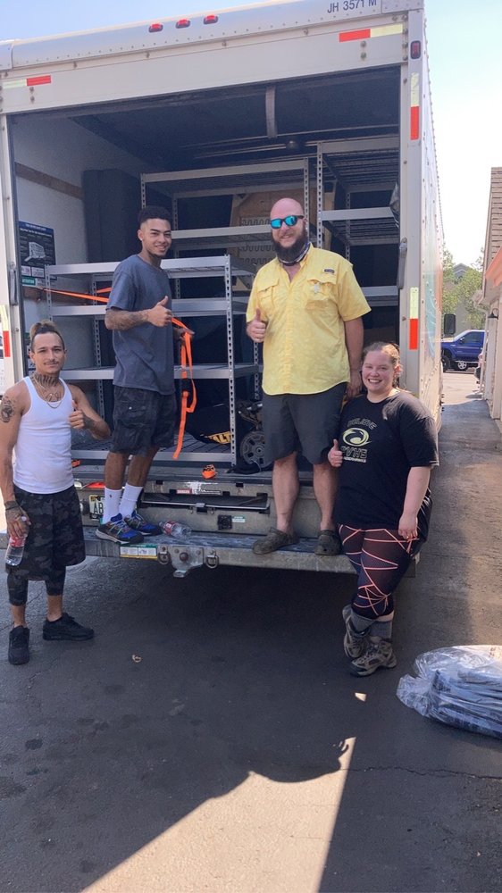 A full Anytime Movers crew ready to load a 26-foot truck